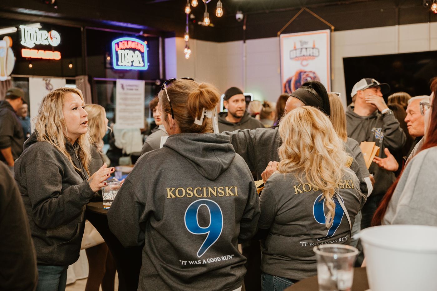 Supporters wearing Koscinski 9 sweatshirts