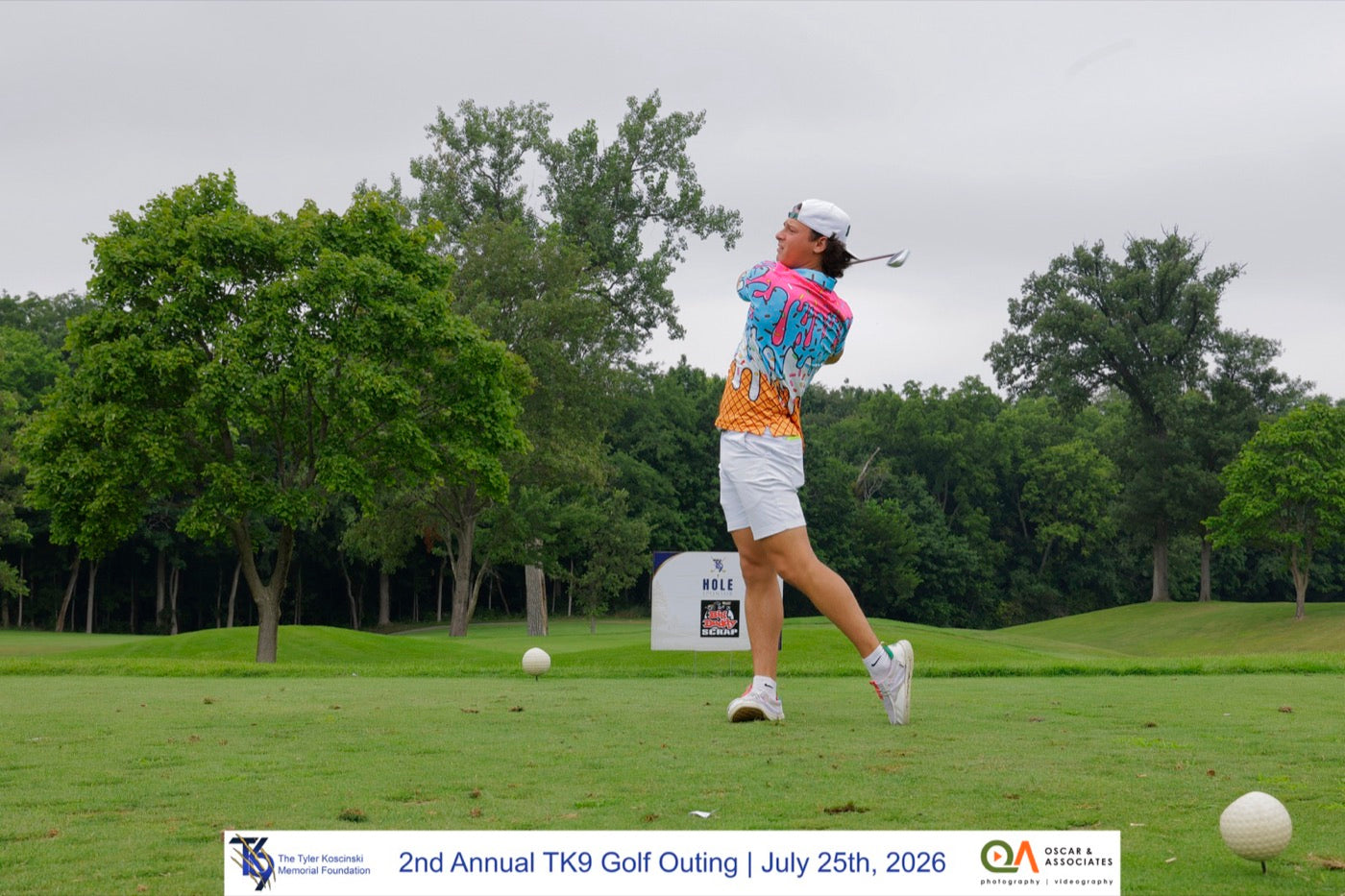 A golfer tees off in a TK9 shirt