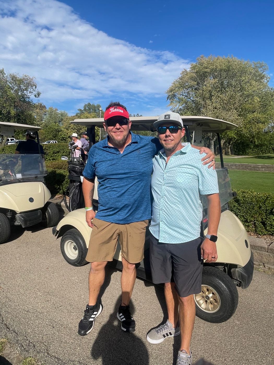 Golfers by their cart